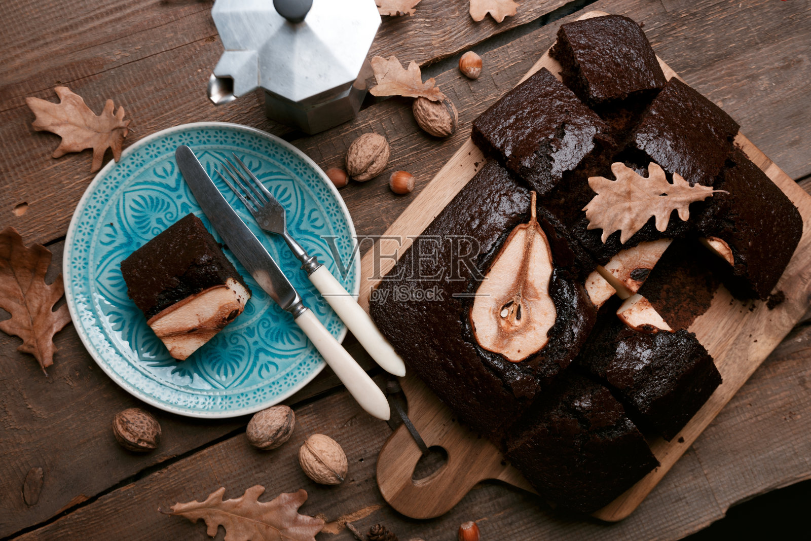 梨子巧克力派。咖啡壶和咖啡杯。静物画“n照片摄影图片