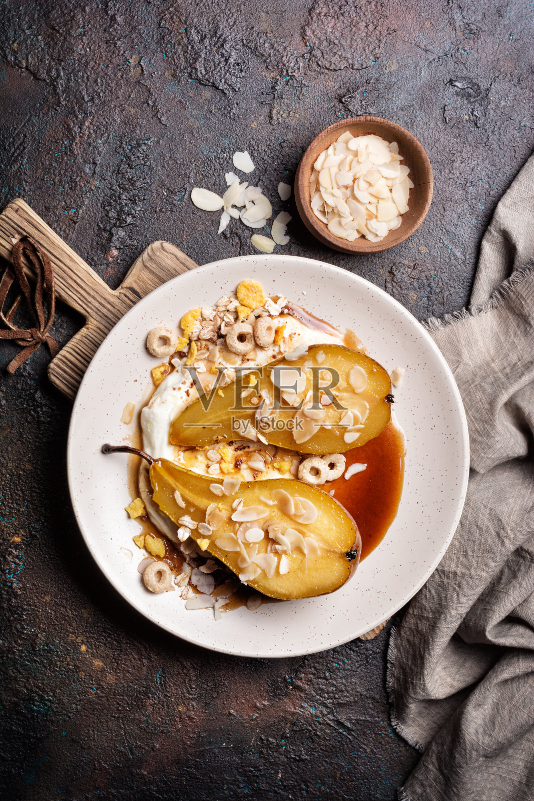水果甜品配烤梨，焦糖酱，芝士奶油和杏仁照片摄影图片
