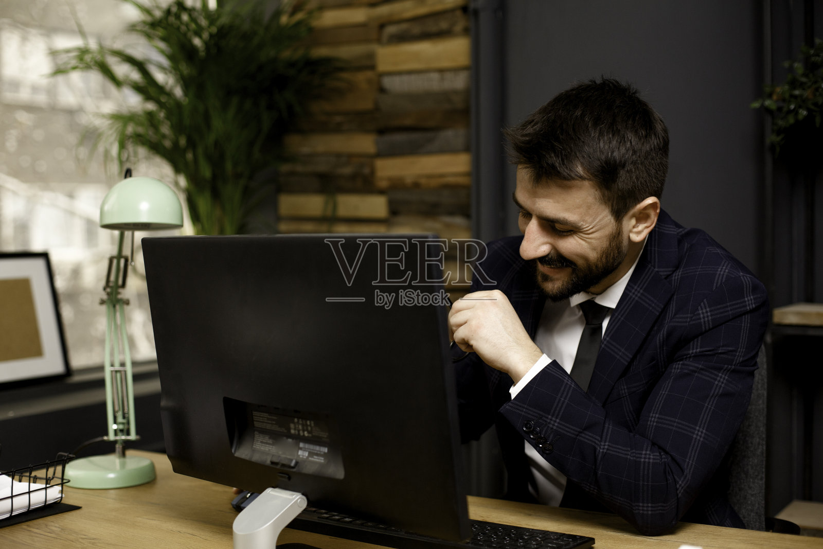 年轻的商人在办公室用电脑工作。照片摄影图片