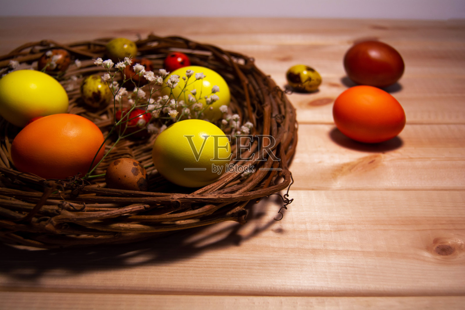 复活节彩蛋放在木桌上的篮子里照片摄影图片
