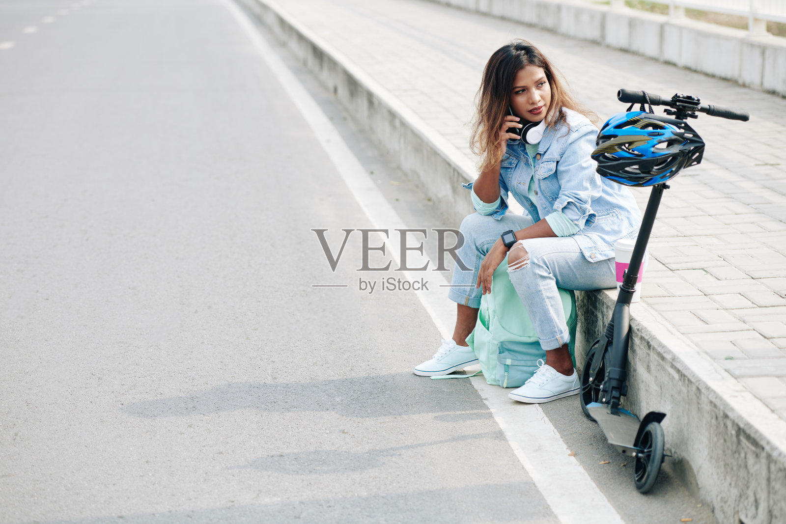 骑摩托车后坐在人行道上照片摄影图片