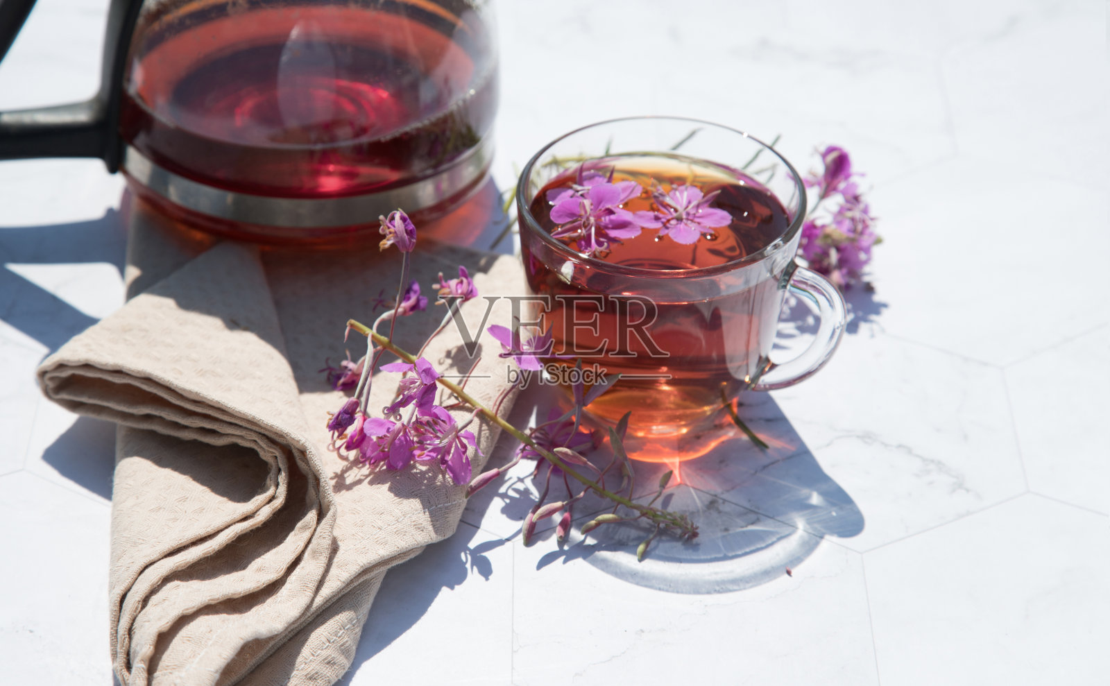 由发酵的印度菊苣叶子制成的草本茶，放在一个玻璃杯子里，旁边放着一个茶壶，里面放着茶叶。传统俄罗斯茶伊凡茶。水平布置。放置副本空间照片摄影图片