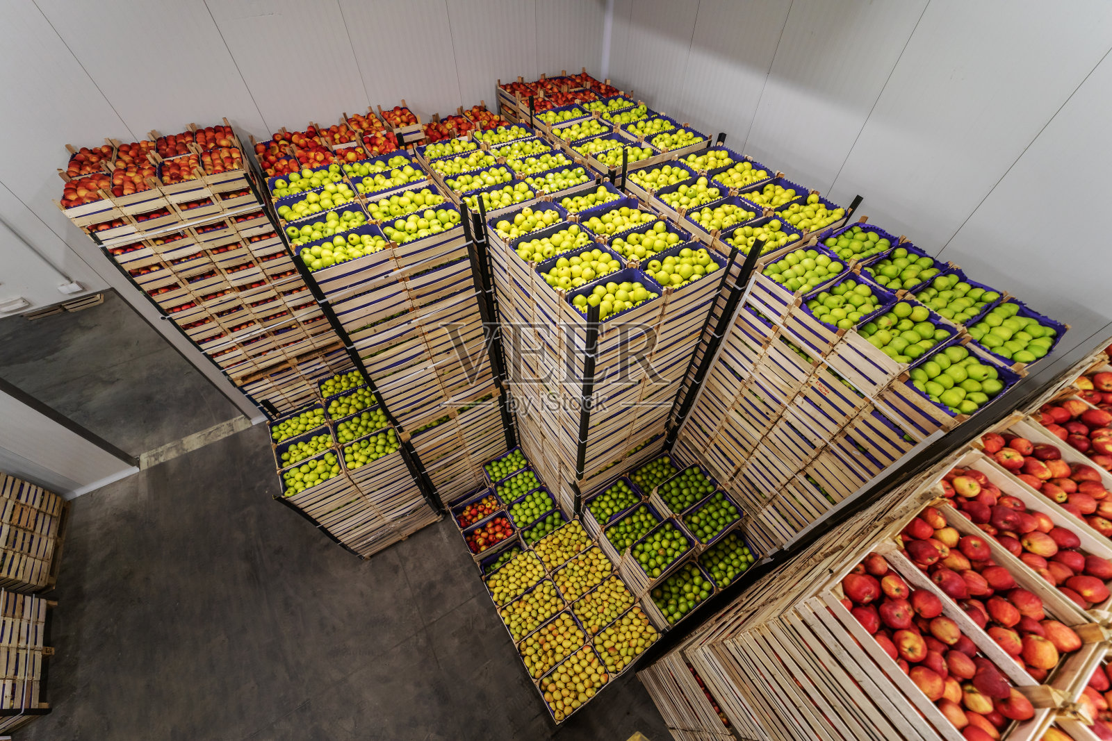 苹果和梨装在板条箱里准备运输。冷藏室内。照片摄影图片