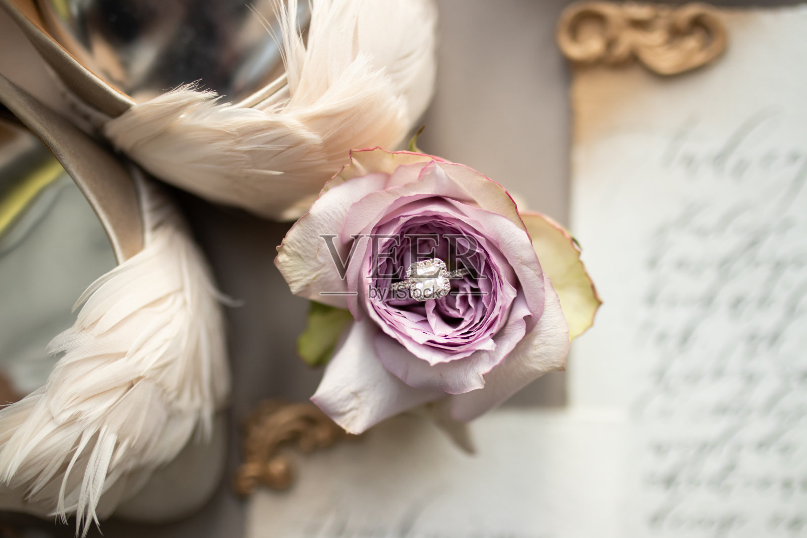 一个婚礼细节，结婚戒指上的紫玫瑰邀请背景照片摄影图片