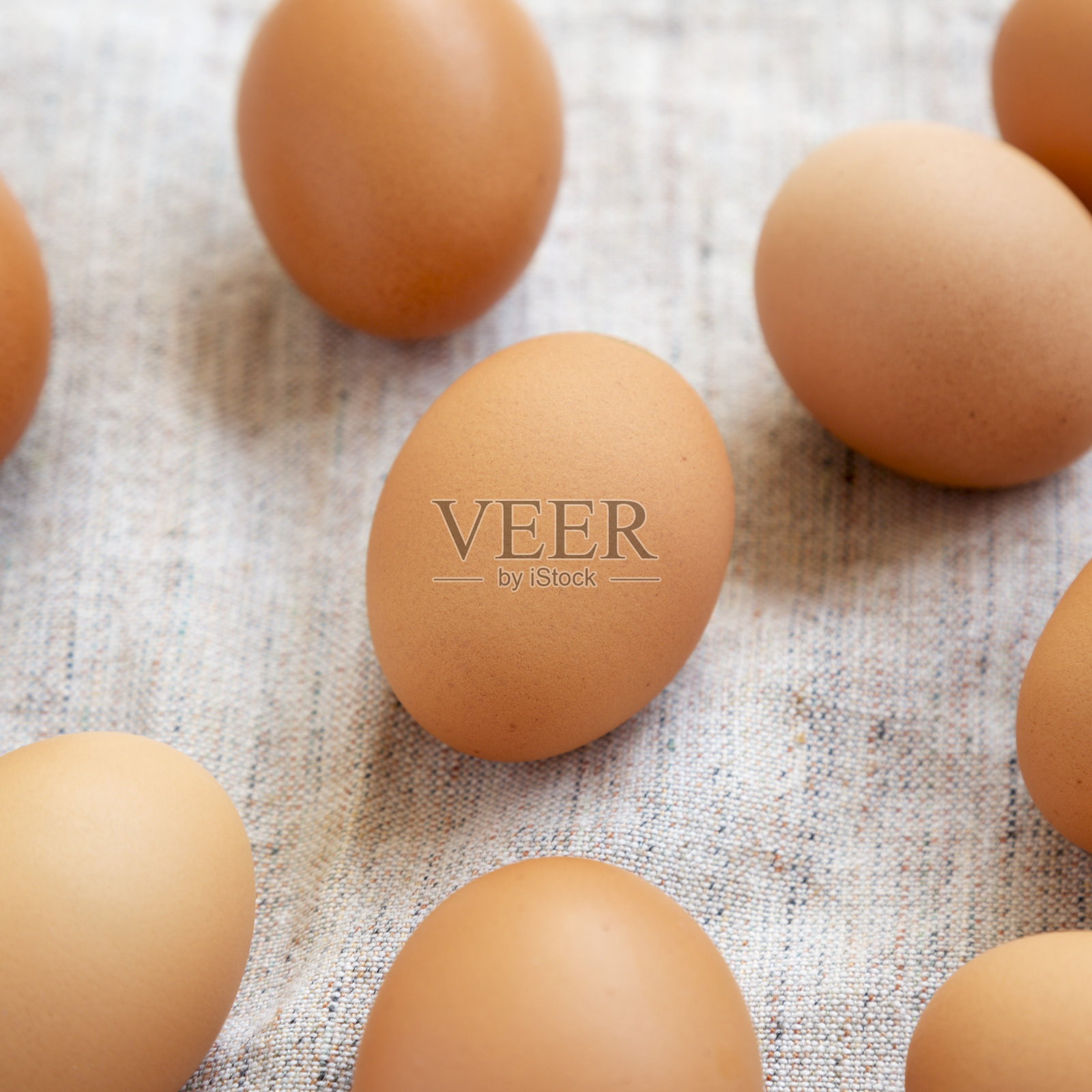 布上的生棕色鸡蛋，侧视图。特写镜头。照片摄影图片