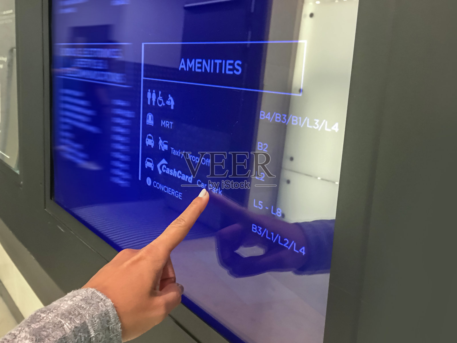 东南亚女人触摸购物中心互动目录的屏幕照片摄影图片