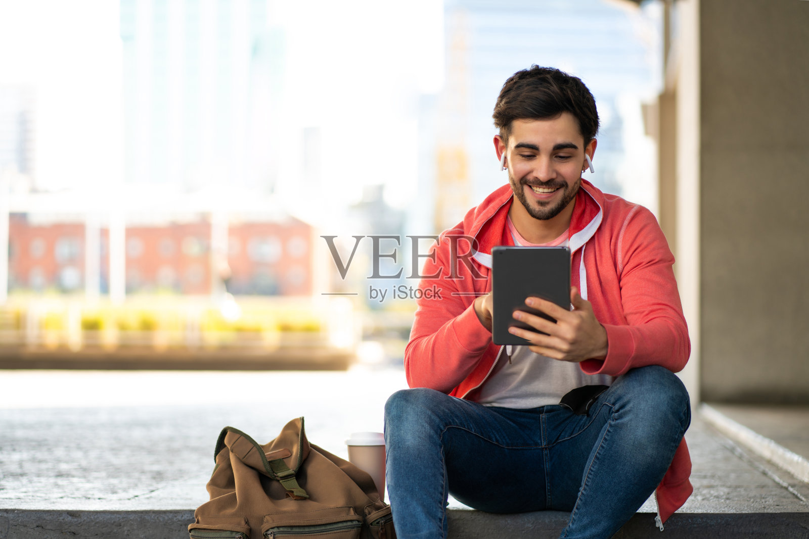 年轻人在户外使用数码平板电脑。照片摄影图片