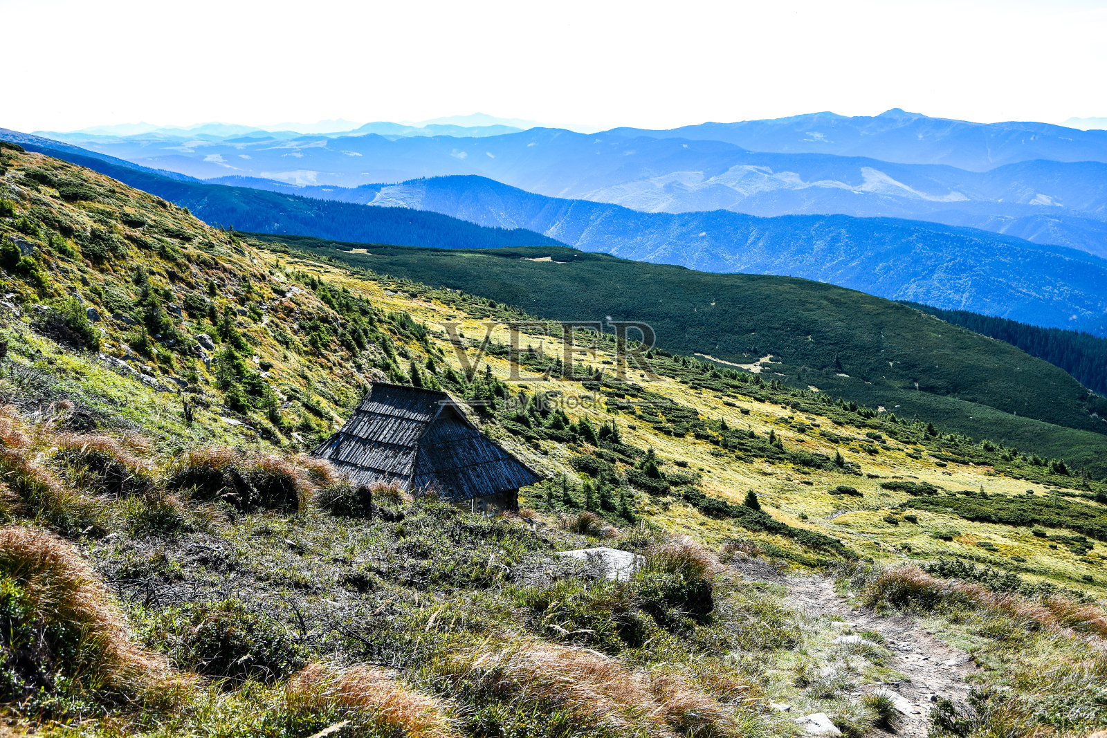 夏日日落时山间宁静的废弃小屋。乡村的房子。山上的木屋照片摄影图片