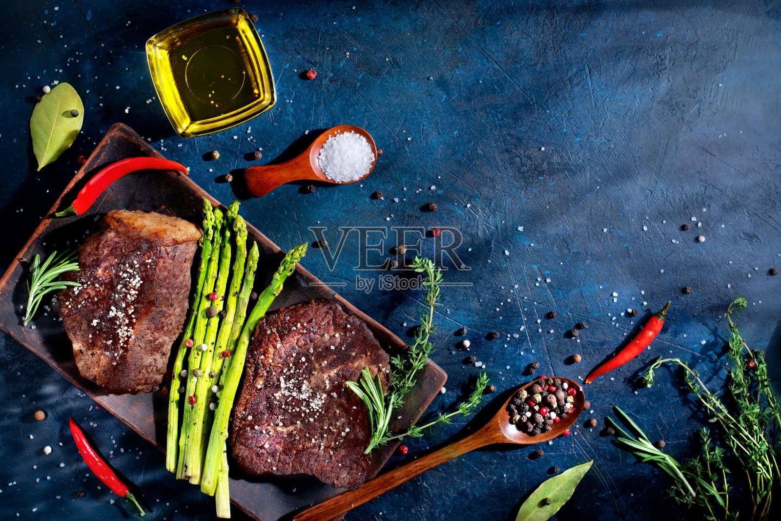 两份牛排，烤牛肉配蔬菜，芦笋，香料照片摄影图片