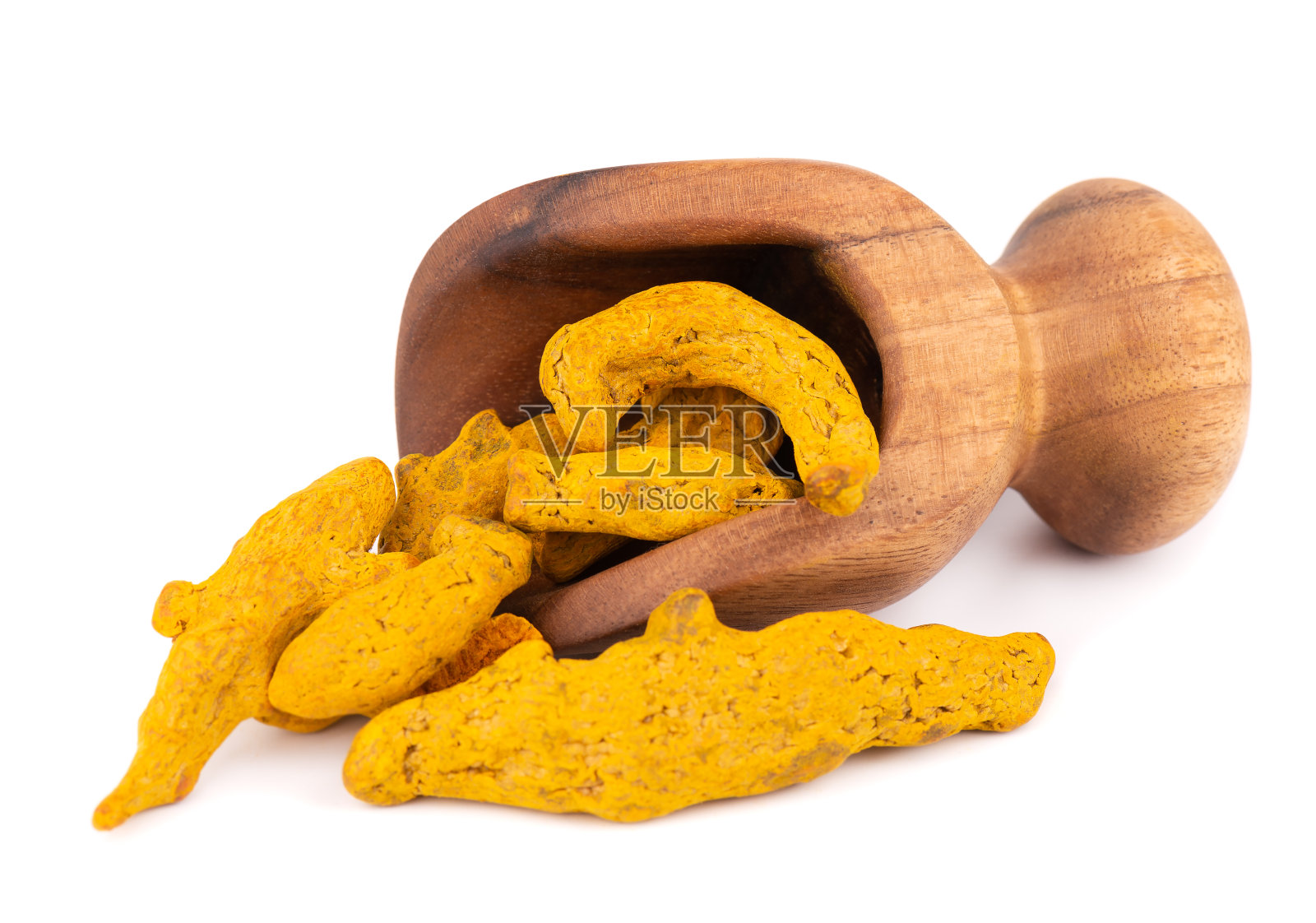 用木勺舀干姜黄根，孤立在白色背景上。姜黄绝壁。照片摄影图片