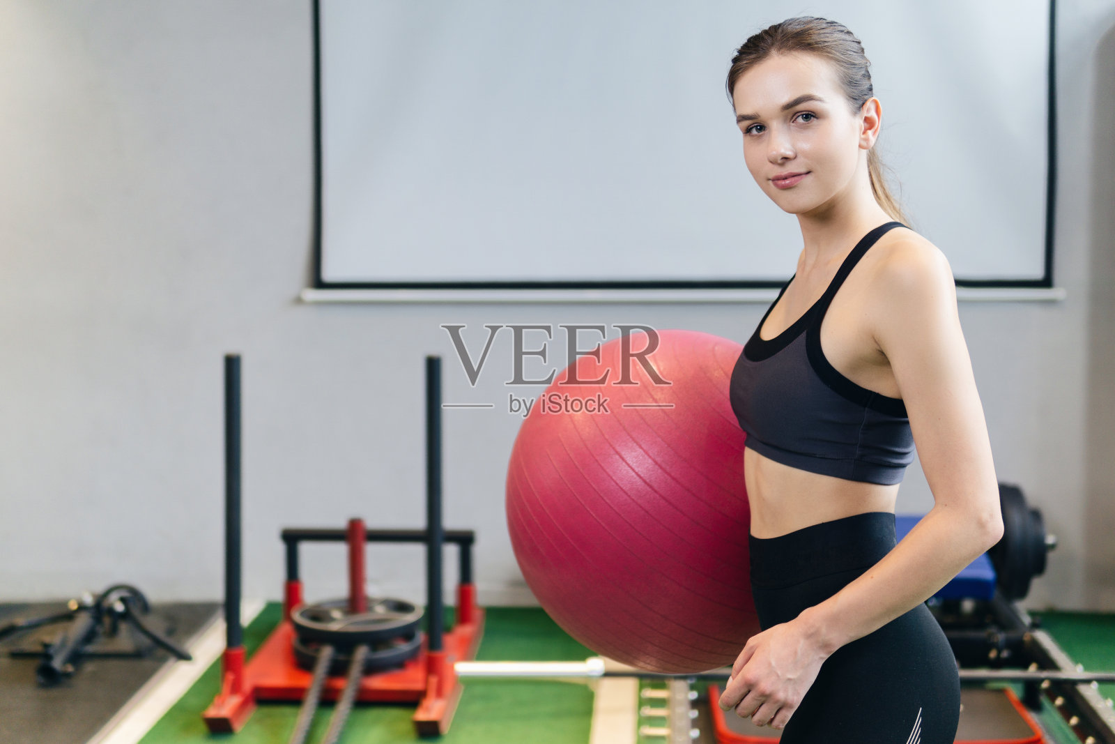 女孩拿着粉色的健身球。普拉提和健身。照片摄影图片