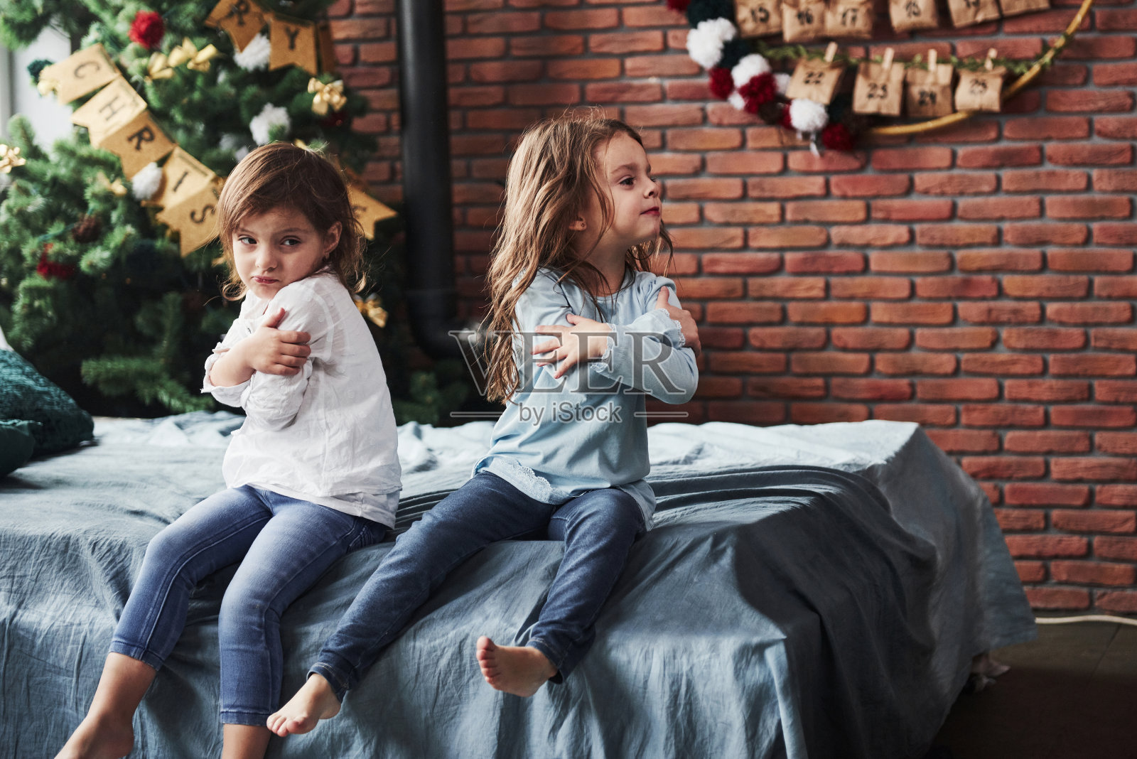 互相冒犯。在漂亮房间里的孩子们在新的一年里心情有些不好照片摄影图片