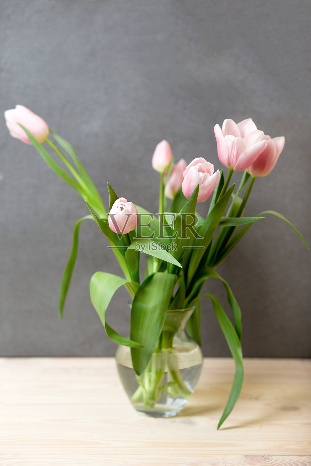 春天舒适的组合，粉红色的郁金香在家里的花瓶照片摄影图片
