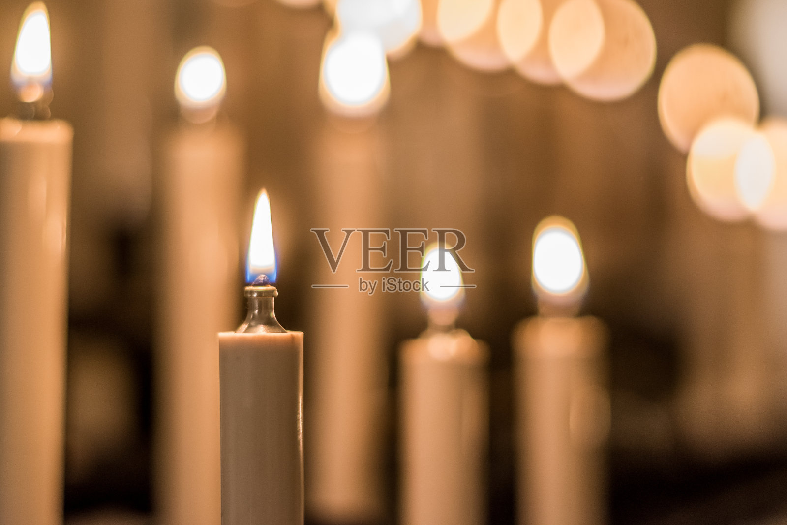 信仰、灵性和宗教观念。蜡烛形状的油灯在教堂或寺庙中发光。卫塞节或佛教的佛日。照片摄影图片