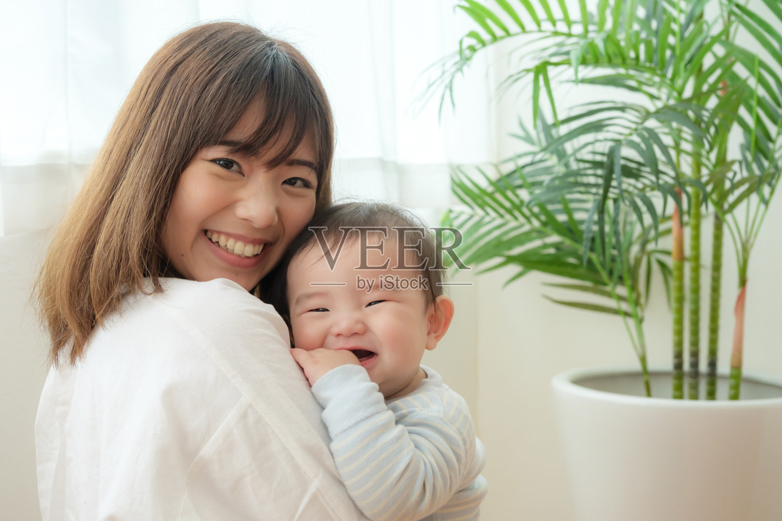 年轻的亚洲母亲和婴儿在客厅里照片摄影图片