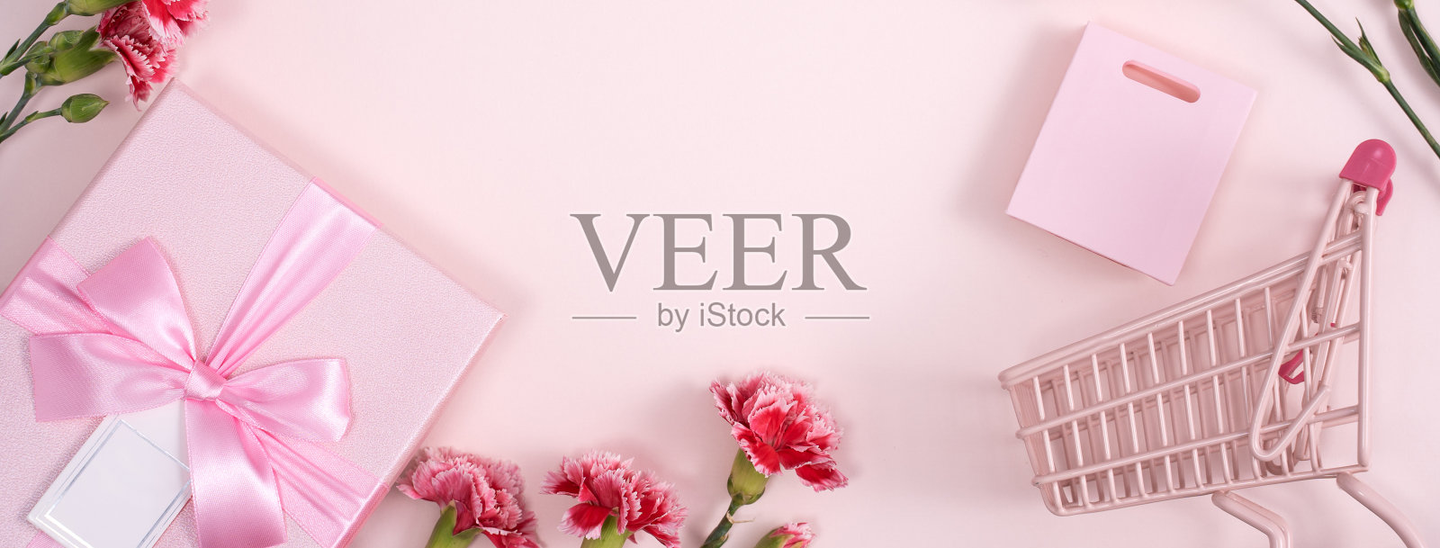 以粉红色背景的康乃馨花束作为母亲节节日问候的概念照片摄影图片