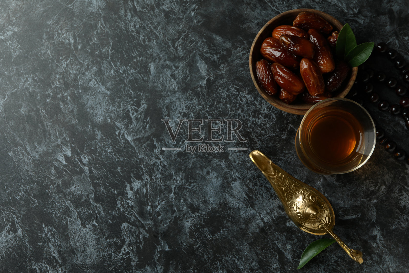 斋月的概念与食物和附件在黑色烟熏背景照片摄影图片