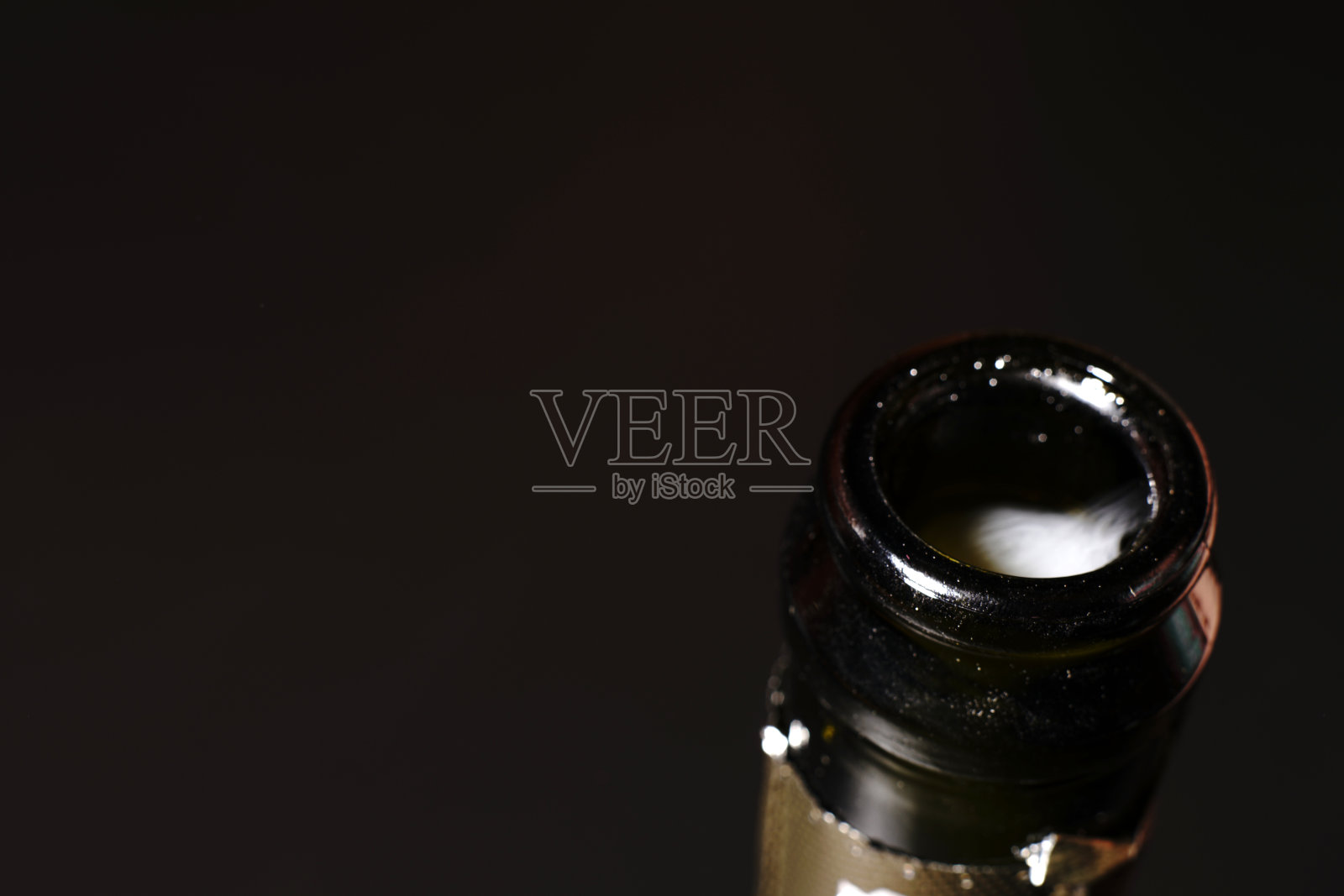 黑色背景下的香槟瓶盖。特写镜头。可见的烟雾从气体。照片摄影图片