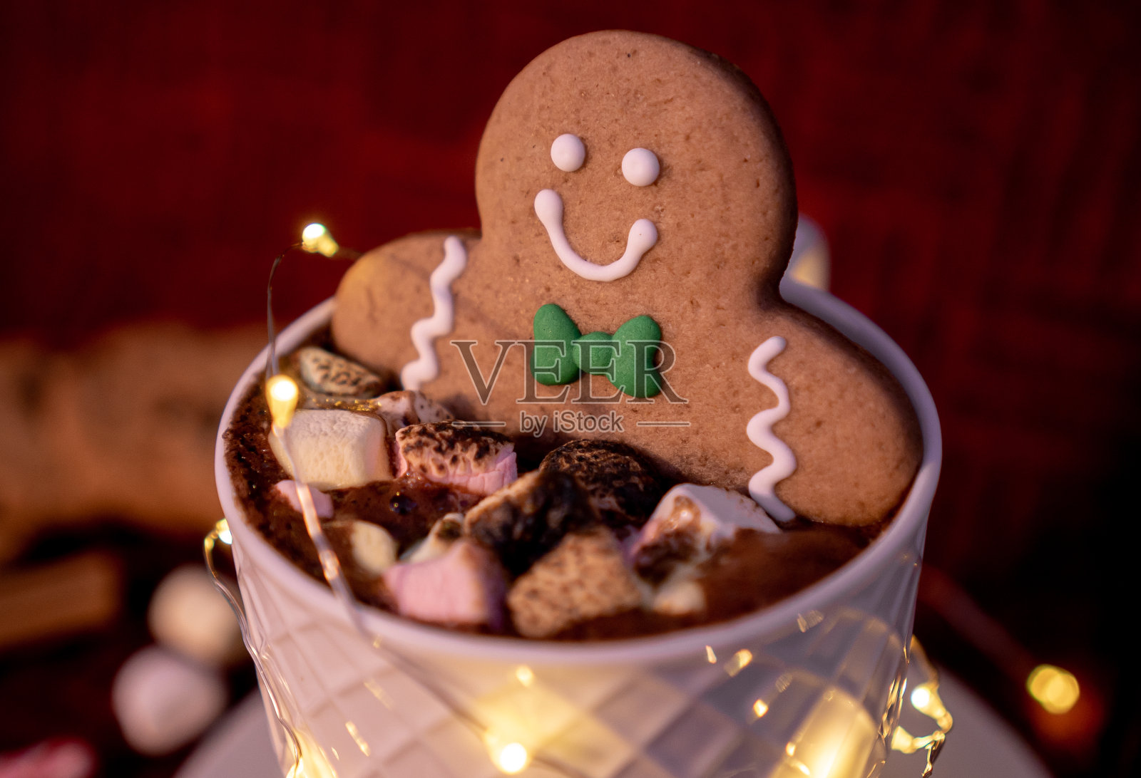 一杯美味的热巧克力配姜饼人饼干蘸肉桂巧克力，是圣诞贺卡的理想选择。照片摄影图片