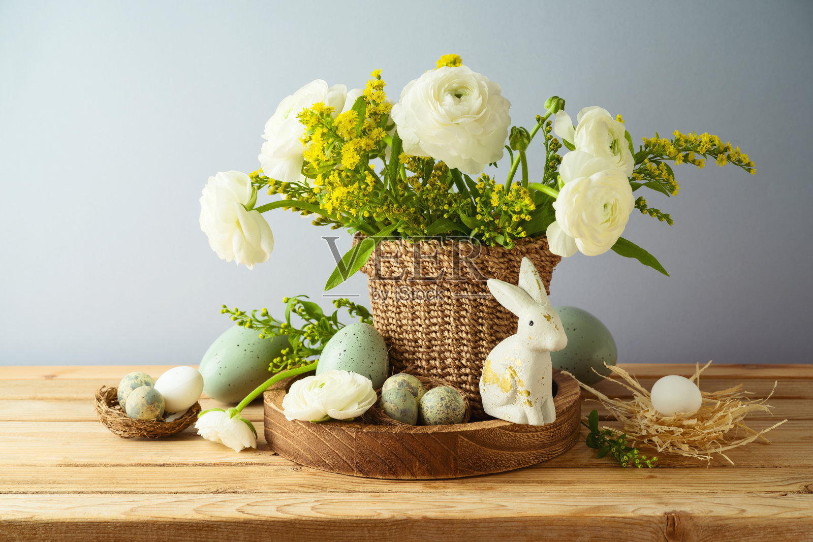 复活节节日的概念与美丽的鲜花，花束和复活节彩蛋装饰在木桌上照片摄影图片