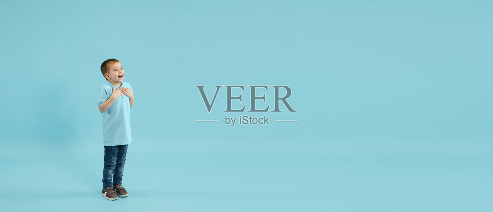 童年和梦想的伟大和著名的未来。漂亮的小男孩被孤立在蓝色背景上照片摄影图片