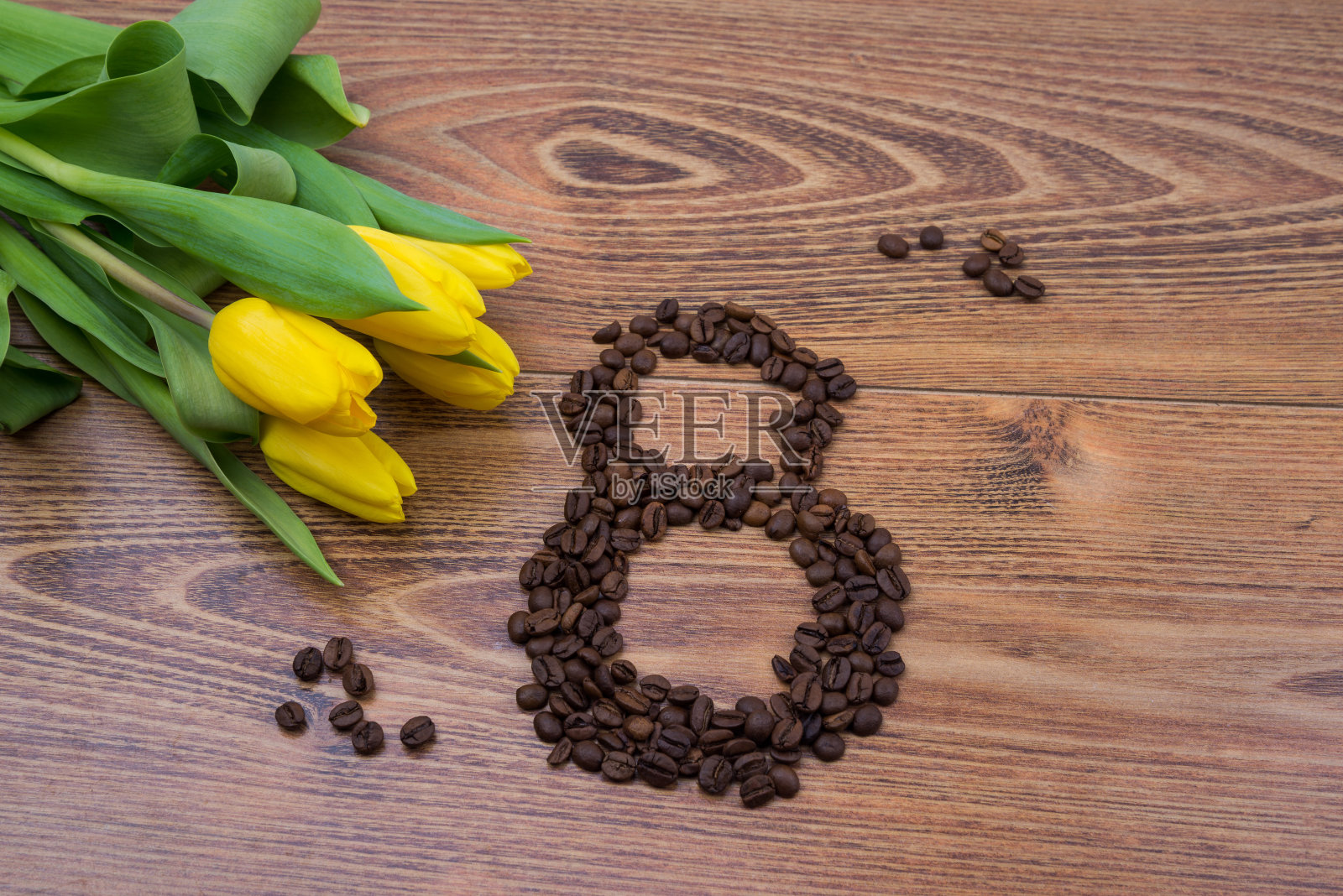 3月8日，深色木质背景上点缀着黄色郁金香和咖啡豆。妇女节贺卡照片摄影图片