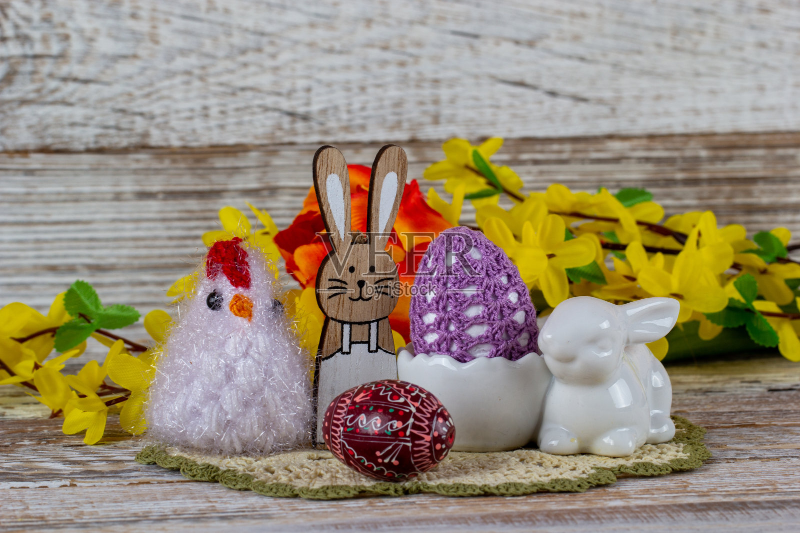 复活节兔子，小鸡，复活节彩蛋和春天的花朵放在一张木桌上。照片摄影图片