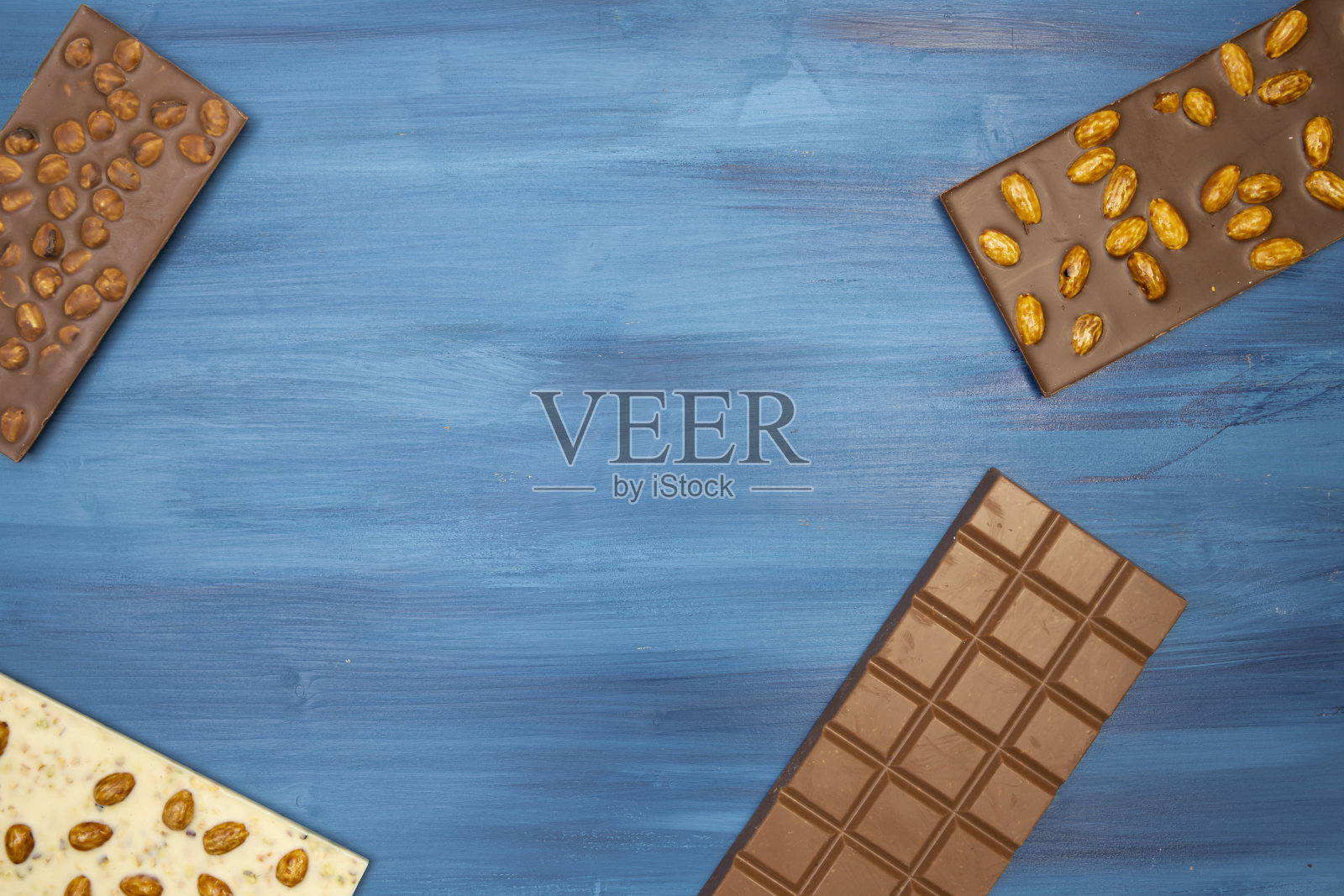 许多不同的美味巧克力棒在蓝色的背景照片摄影图片