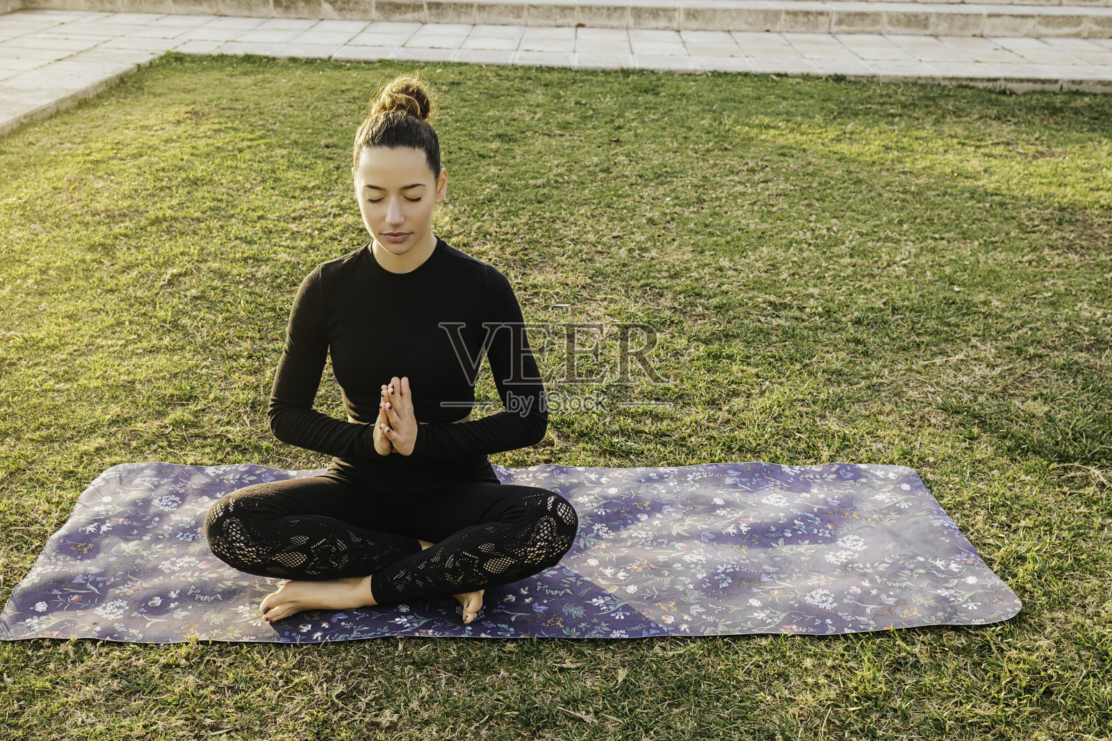 年轻女子在夕阳下做瑜伽姿势照片摄影图片