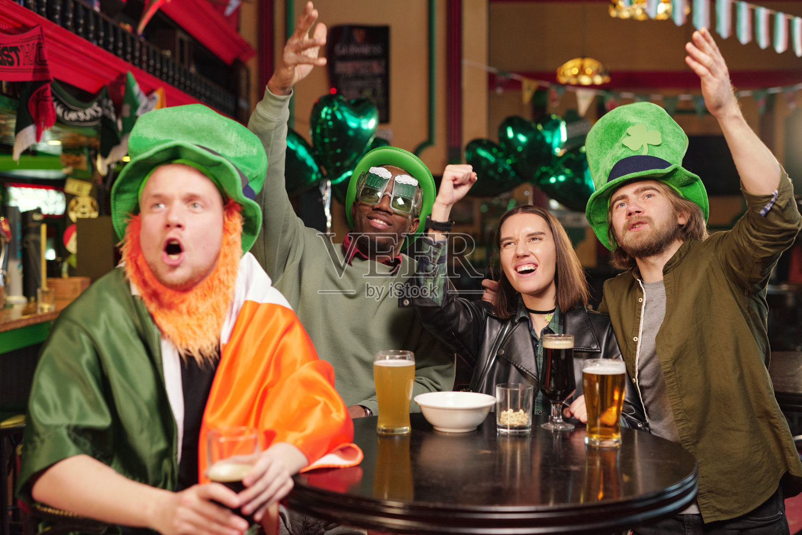 人们在酒吧里为运动队欢呼照片摄影图片