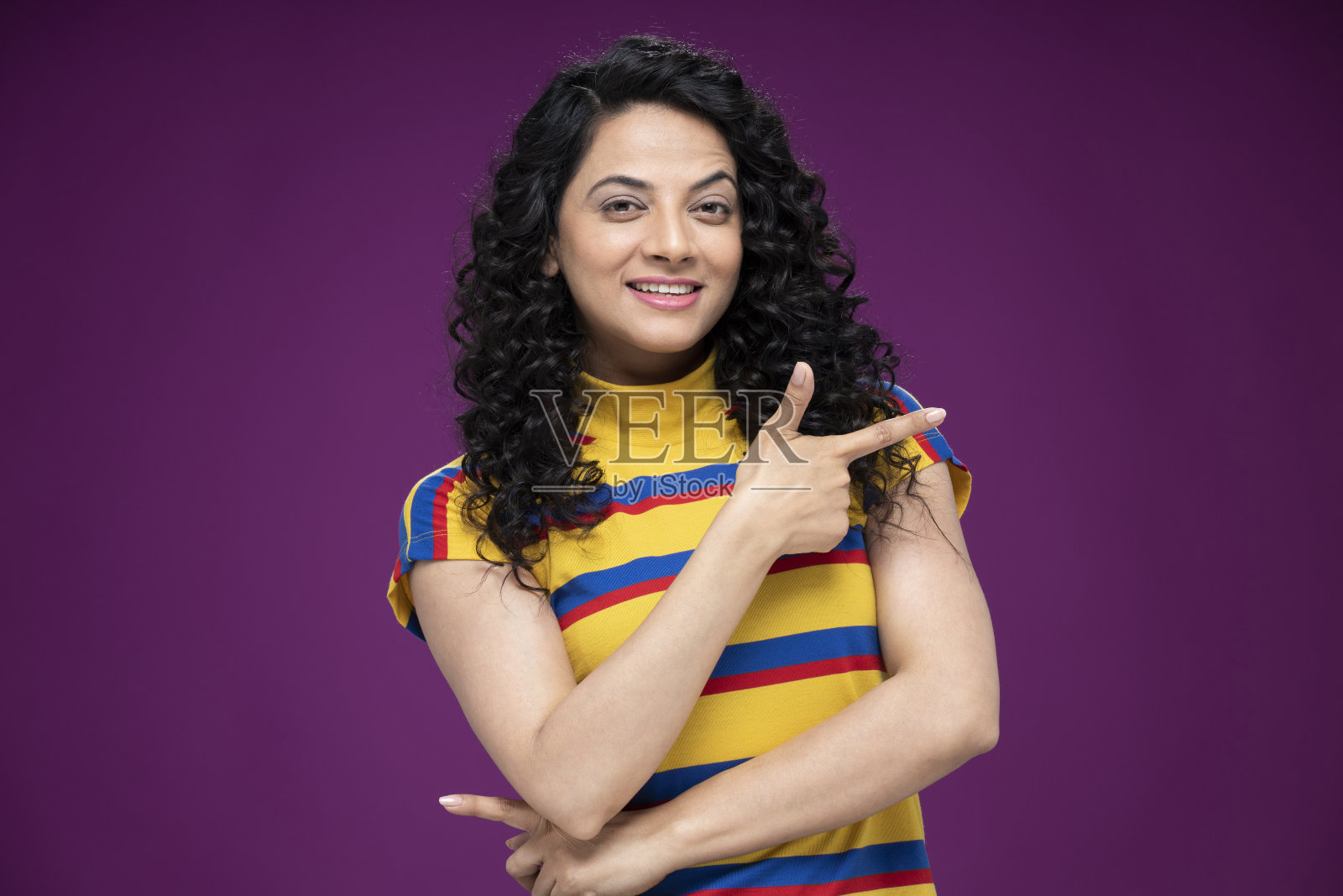 一个年轻女子站在孤立的紫色背景:-库存照片照片摄影图片