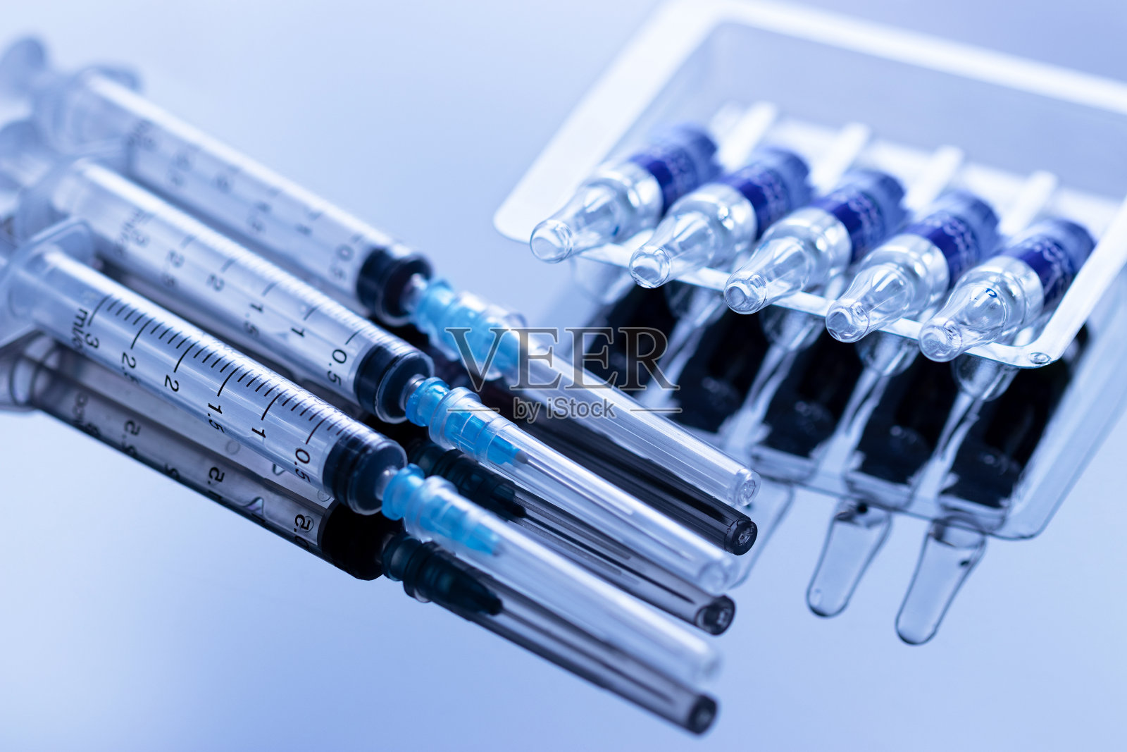 安瓿排成一排，注射器用针照片摄影图片