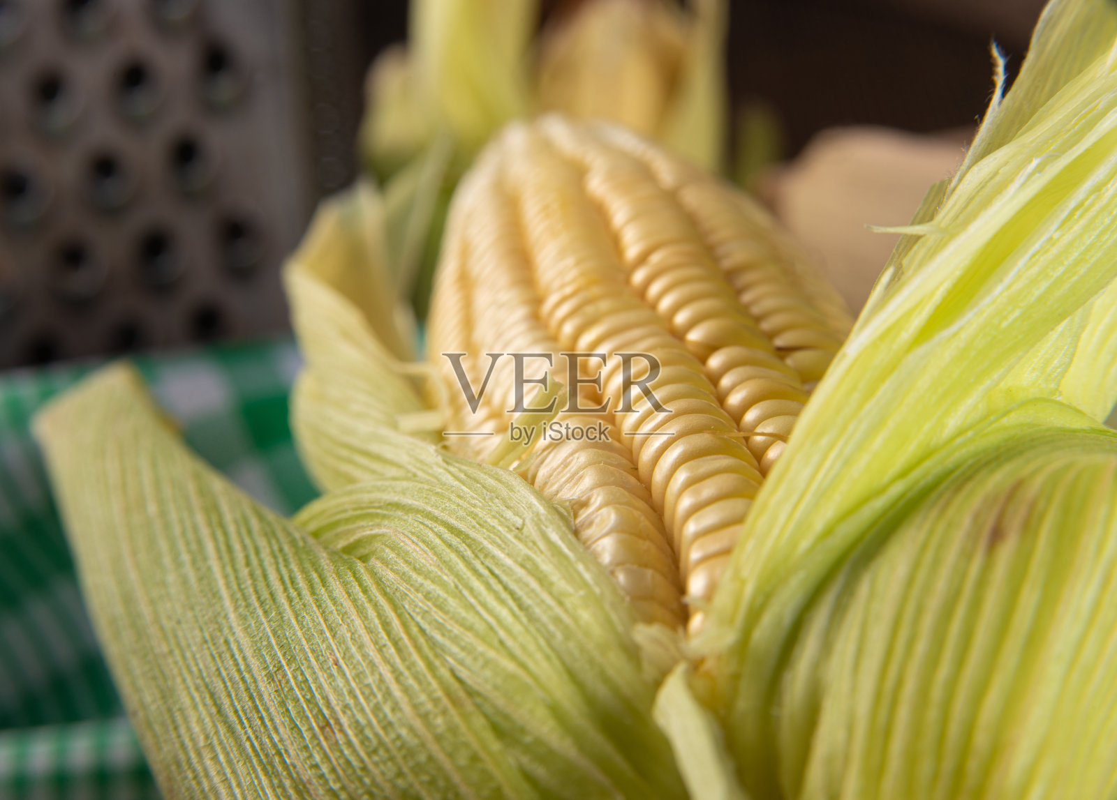 在巴西的Festa Junina，绿玉米，研磨器和筛子在桌子上，选择性的焦点。照片摄影图片