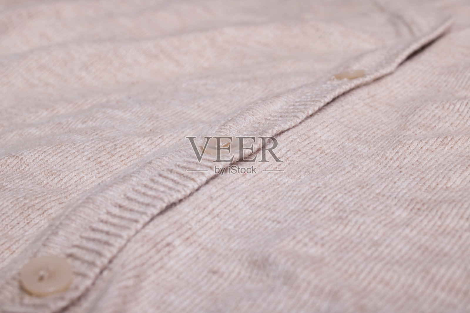 一件米色毛衣上的纽扣靠近了照片摄影图片