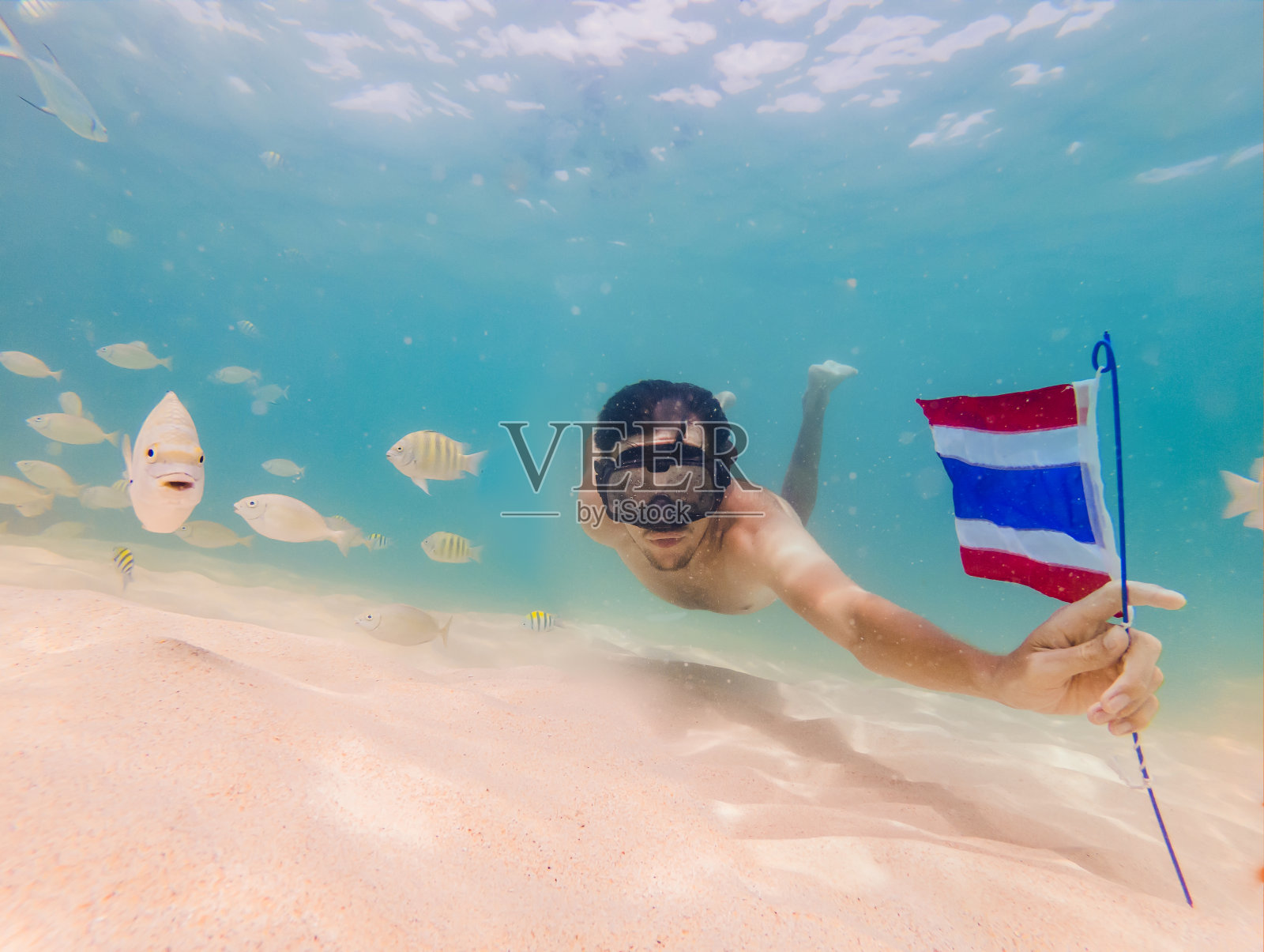 快乐的人在浮潜面具潜水与热带鱼与泰国国旗在珊瑚礁海游泳池。旅行生活方式，水上运动户外冒险，游泳课程在夏季海滩度假照片摄影图片