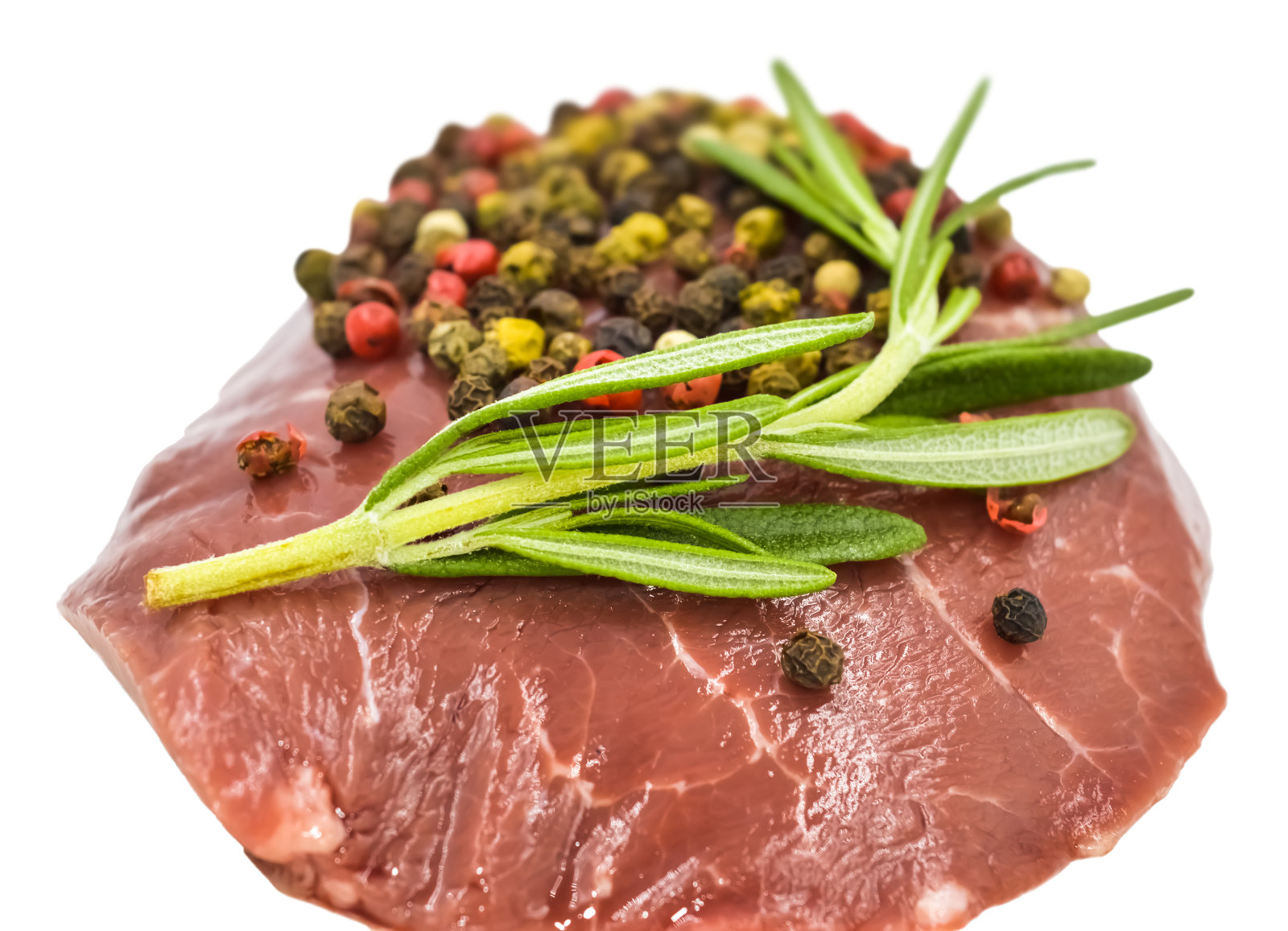 生牛排配迷迭香、黑椒、红椒和青椒照片摄影图片