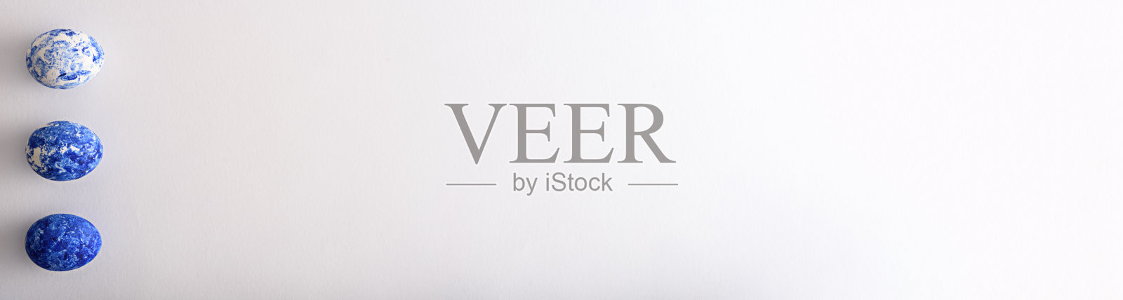 三个带有经典蓝色图案的复活节彩蛋，白色背景上带有渐变效果照片摄影图片