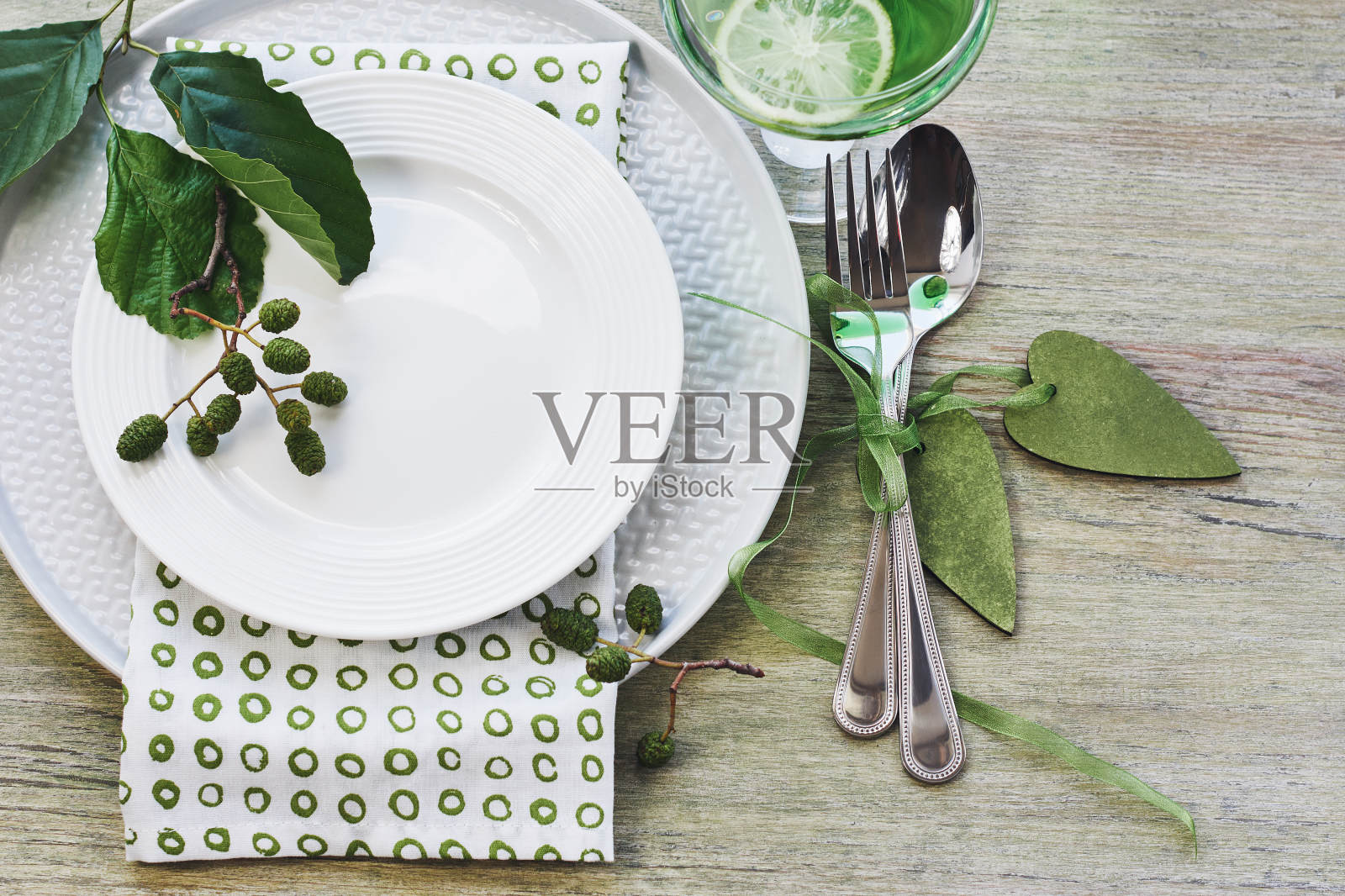 夏季餐桌设置以绿色为主调。照片摄影图片