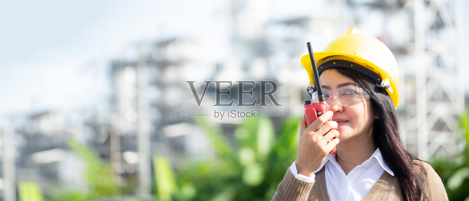 工程师女人拿着无线电，蓝图和报告时间表工人安全控制在发电厂能源工业。工程师和行业概念照片摄影图片