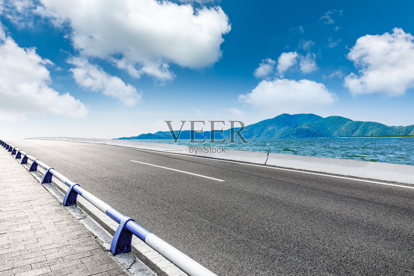 沥青公路和山河自然景观。照片摄影图片