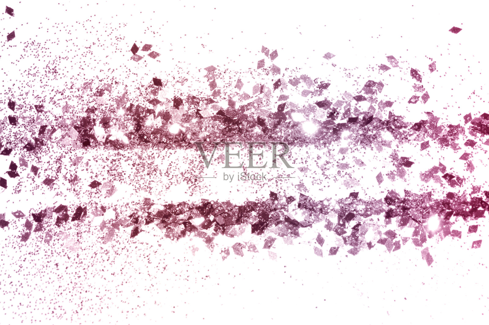 粉红色的亮片在白色的背景上闪闪发光照片摄影图片