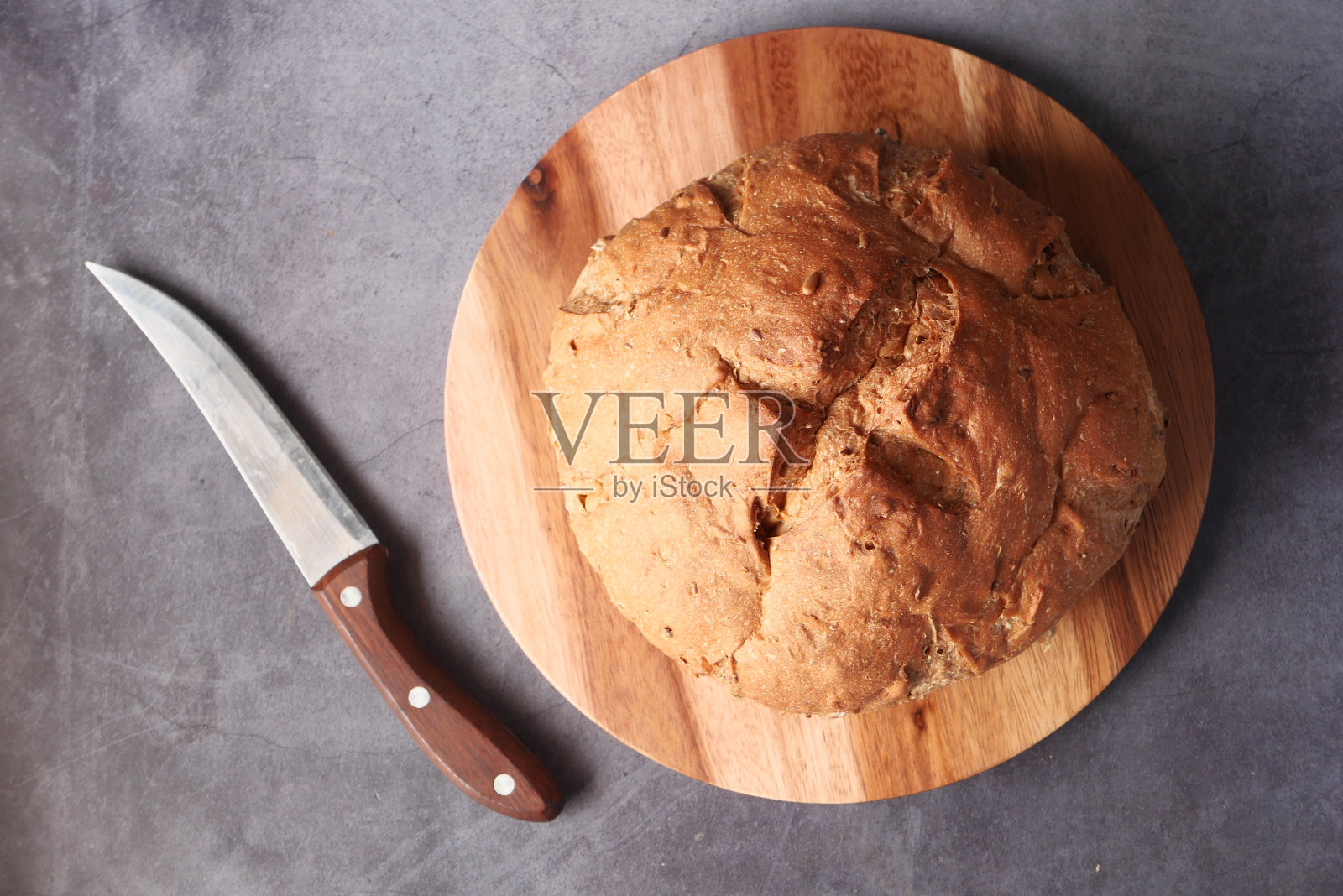 俯视图圆棕色烤面包在切板上照片摄影图片