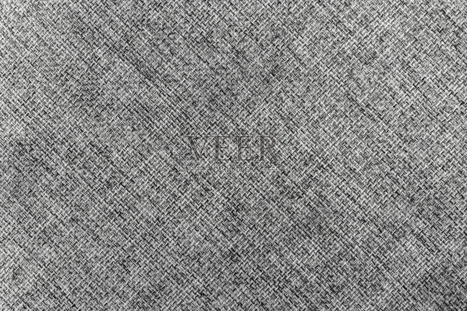 背景由灰色和白色的毛线编织而成。照片摄影图片