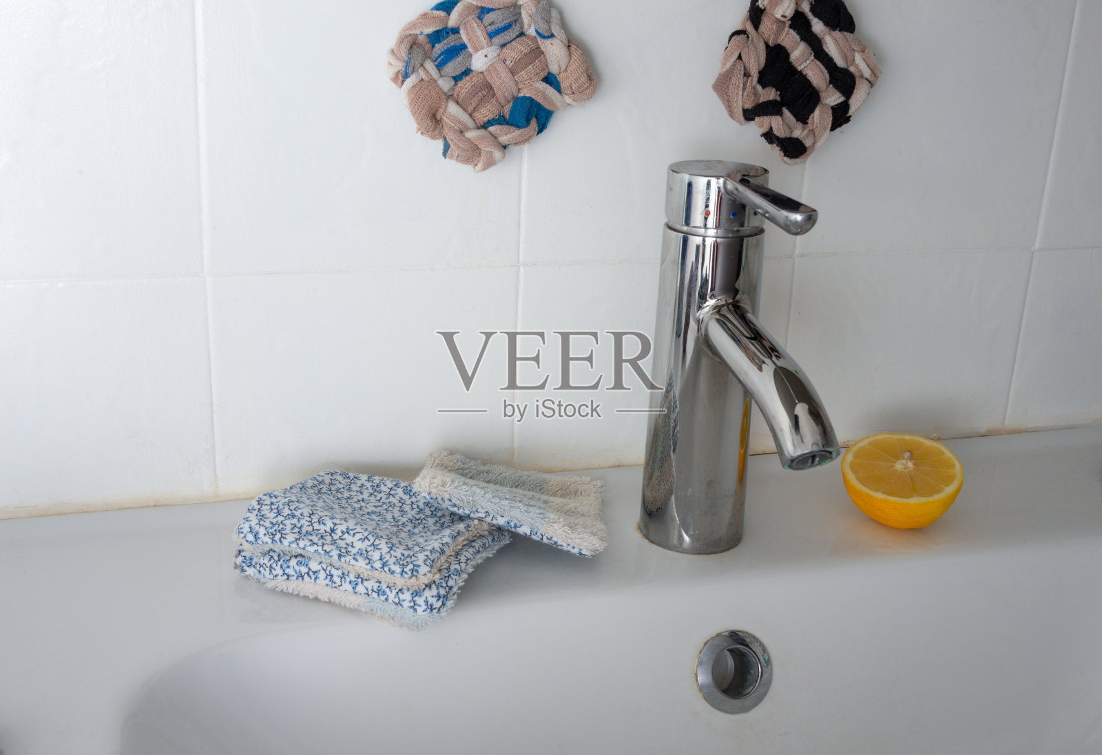 浴室里可重复使用的手工化妆或面部湿巾，上面放一块切好的柠檬照片摄影图片