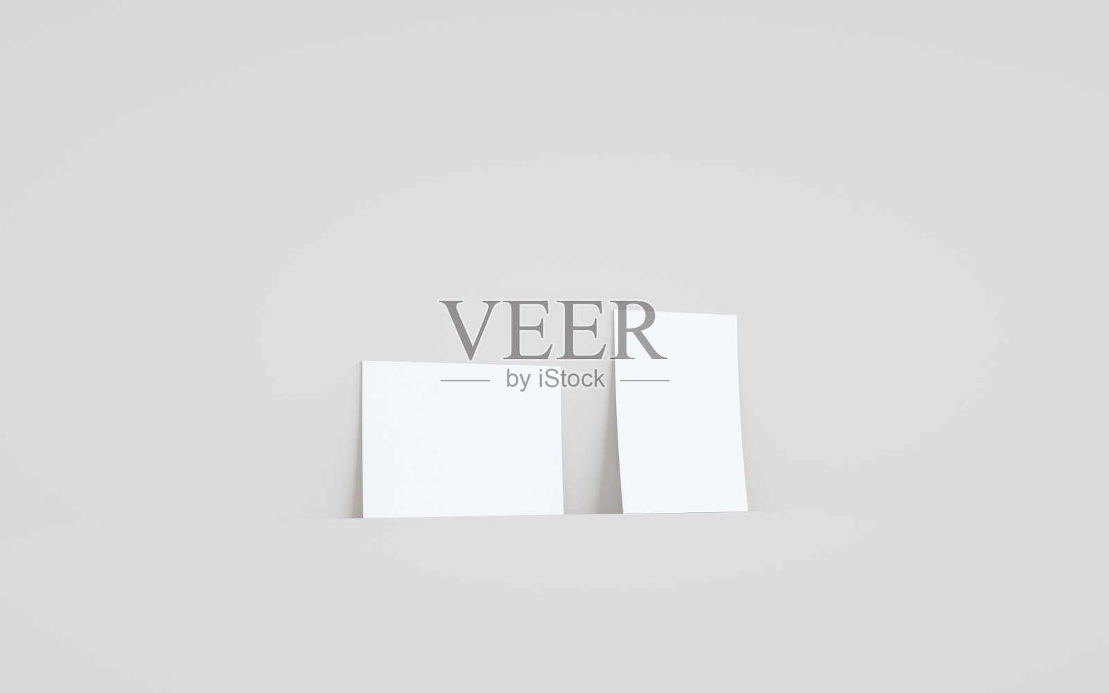 A6传单/小册子模型-两张传单对着墙的背景照片摄影图片