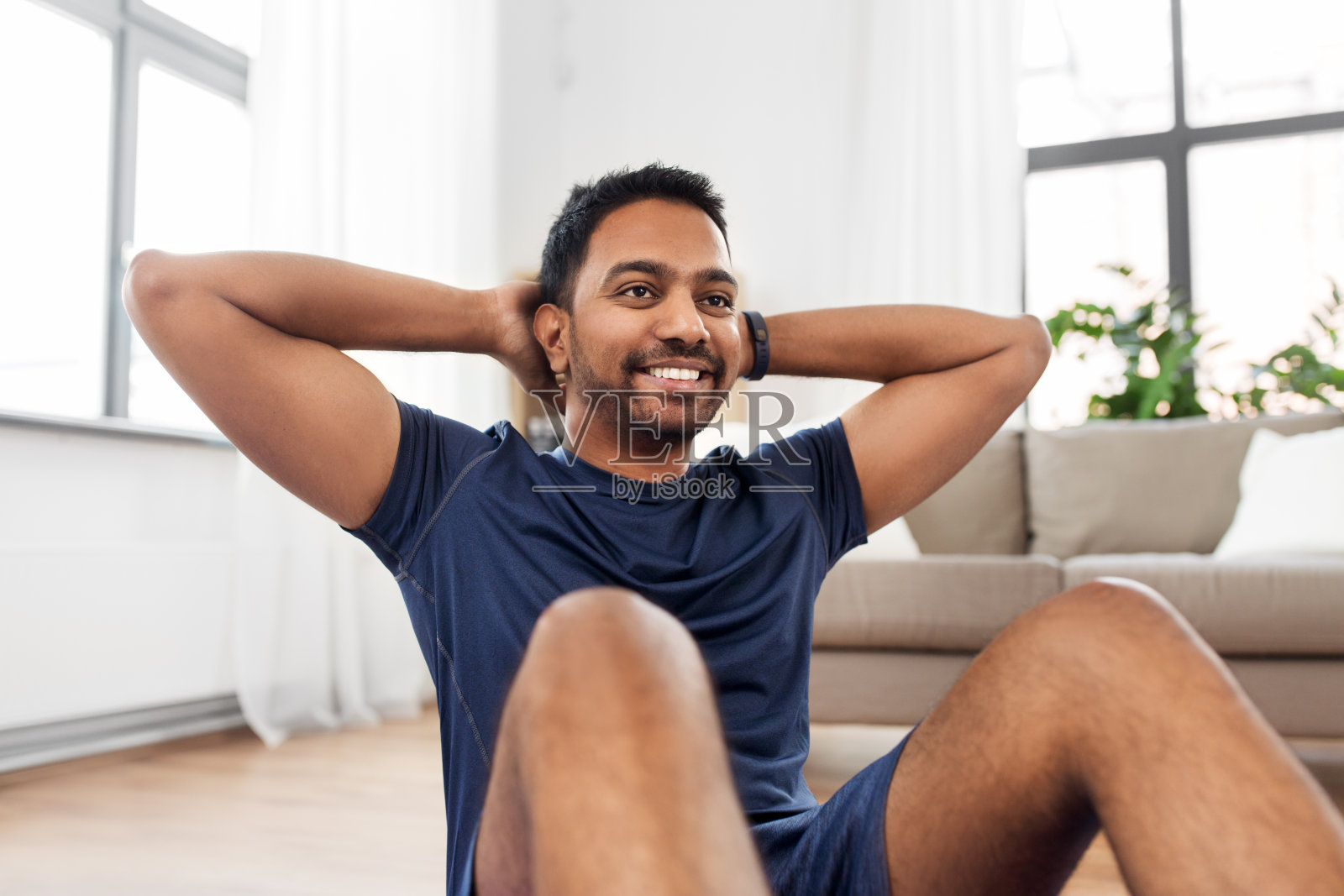印度男子在家里做腹部运动照片摄影图片