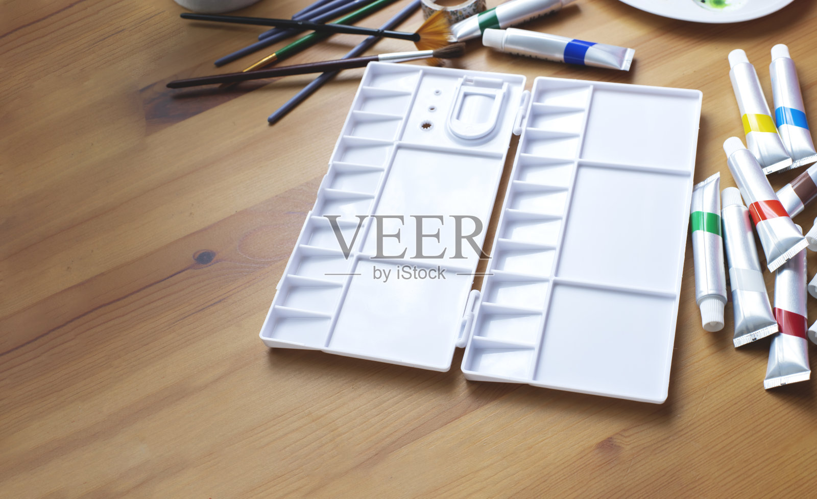 清空水彩调色板，用管子和画笔作画照片摄影图片