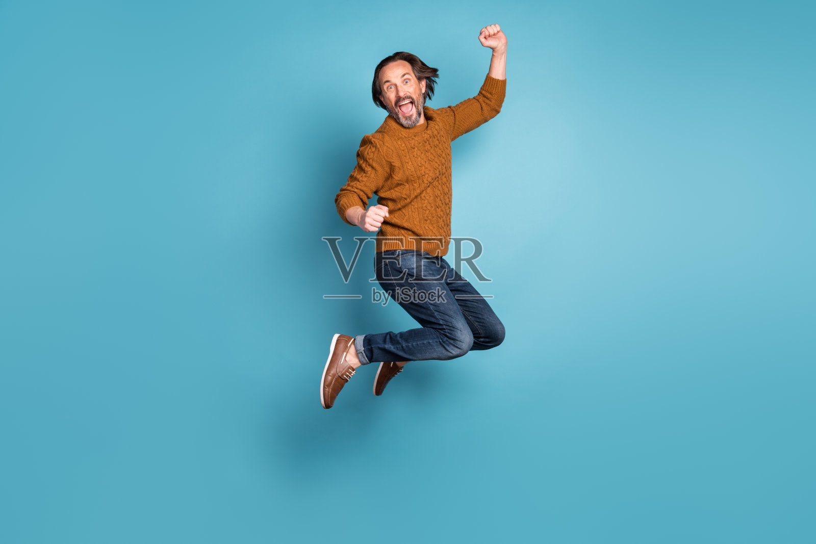 成熟英俊的全尺寸照片兴奋疯狂微笑的男人在成功中跳跃胜利孤立在蓝色背景照片摄影图片