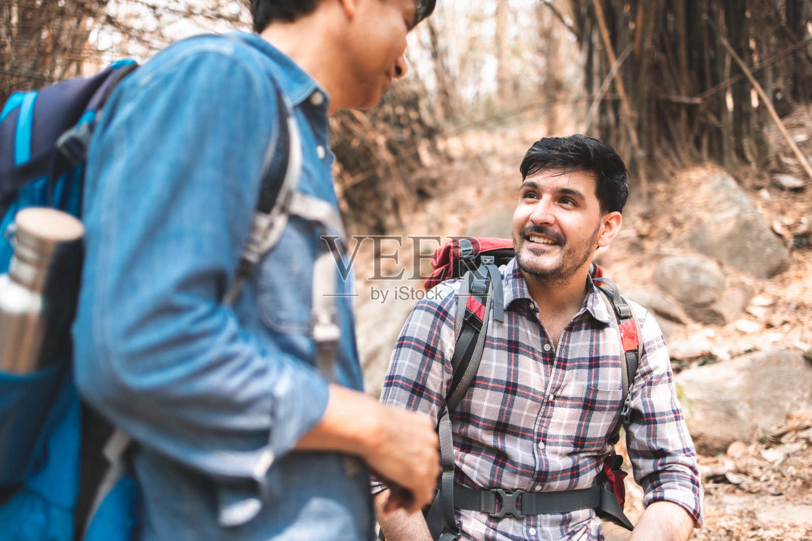 老人拿着相机看着它。旅行团队和家庭放松散步在户外生活方式的冒险和露营。照片摄影图片