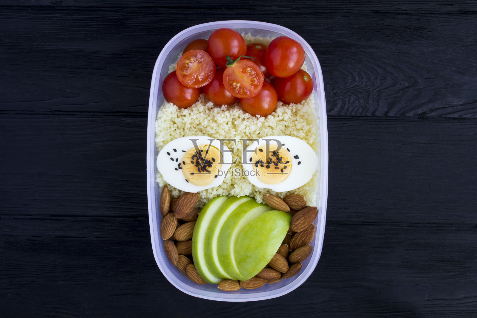 黑色木制背景上的素食午餐。前视图。照片摄影图片